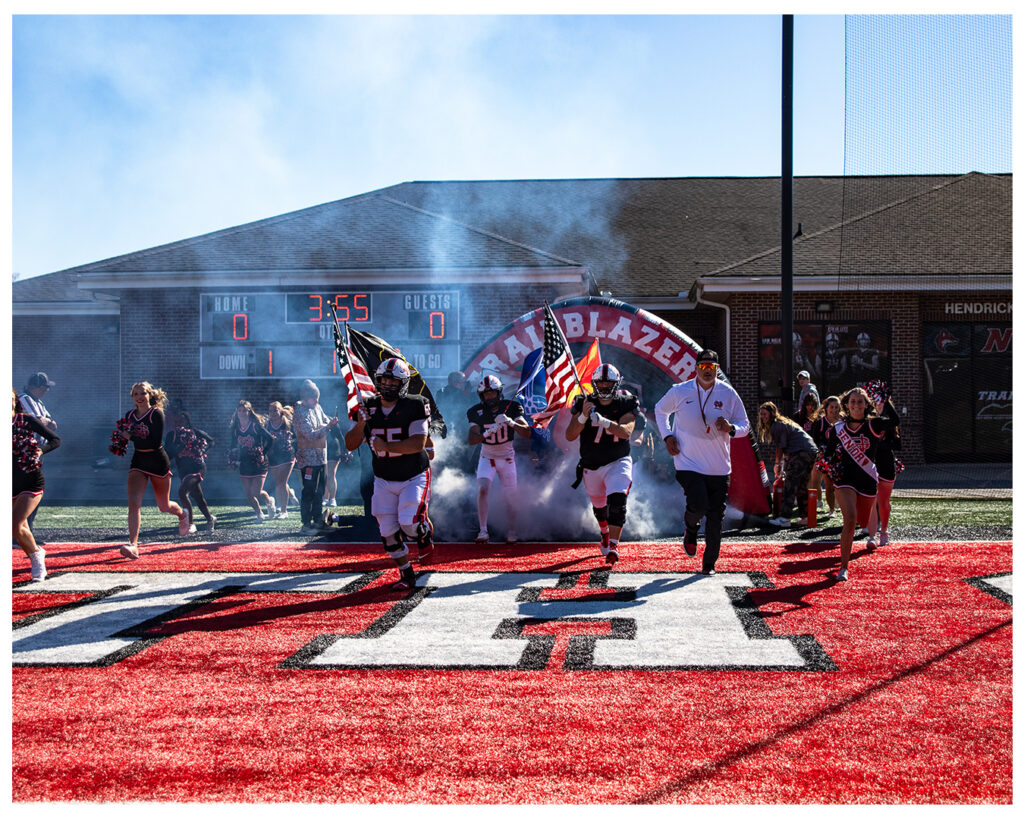 Coach Nate Garner running onto the field